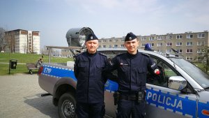 Dwóch policjantów z radiowozem