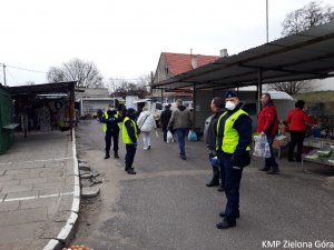 Trzech Strażników Miejskich na tle targoeiska