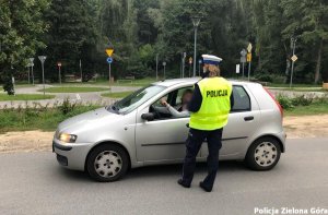 Policjantka ruchu drogowego rozmawia z kierującym samochodem osobowym