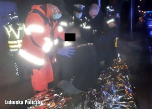 Ratownicy medyczni i policjanci pomagają poszkodowanemu