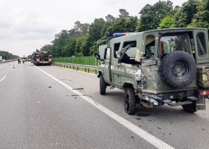 Uszkodzony zielony samochód z napisem &amp;quot;Regulacja Ruchu&amp;quot; stojący na prawym poboczu.