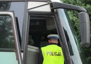 Zbliżenie na policjanta który kontroluje autobus.