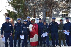 Grupa policjantów wraz z bachusem pozują do zdjęcia.