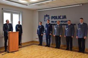 pięciu policjantów stojących na baczność.